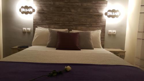 a bedroom with a large bed with two lights at City Space Apartments in Giannitsa