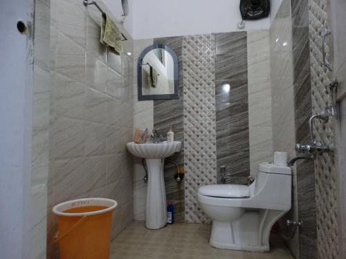 a bathroom with a toilet and a sink at Nainital Adventure Park & Resort in Nainital