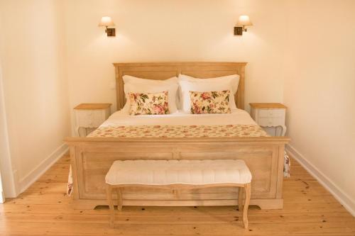 a bedroom with a large wooden bed with two pillows at Casa Holstein Quinta de Sao Sebastiao Sintra in Sintra