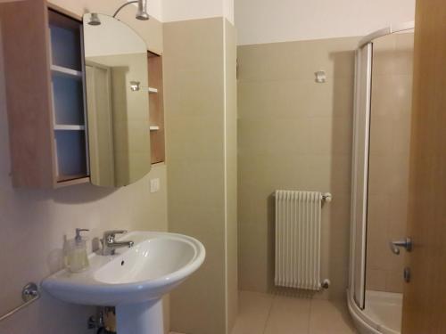 a bathroom with a sink and a shower at Villa Flora in Grado
