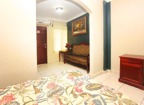 a bedroom with a bed and a couch at Hotel Florencia in San Miguel