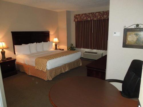 a hotel room with a bed and a table at Super 8 by Wyndham Albany in Albany