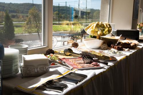 un tavolo con cibo sopra di esso davanti a una finestra di Court Inn a Panagyurishte