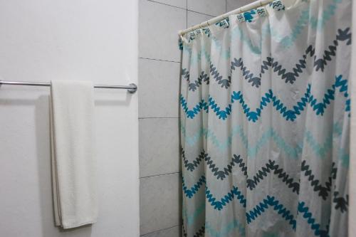 a shower curtain in a bathroom with a shower curtain at Hotel Colon Merida in Mérida