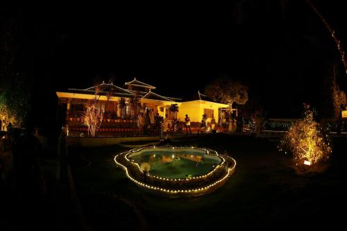 a house with a garden in front of it at night at Green Shades in Munnar
