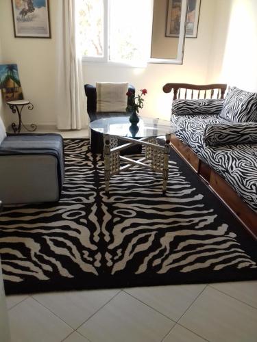 a living room with a zebra rug and a coffee table at Résidence La Galiote in Essaouira