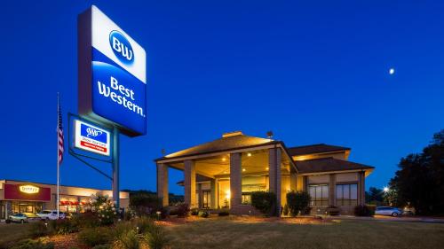 a gas station with a sign in front of it at Best Western Ambassador Inn & Suites in Wisconsin Dells