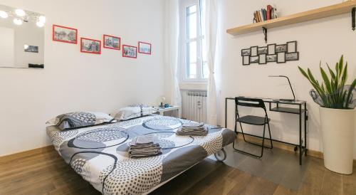 a bedroom with a bed and a desk in it at Borsieri 29 - Heart Of Isola in Milan