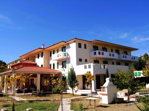 a large white building with a gazebo in front of it at Elimeia 3 Hotel in Aiani