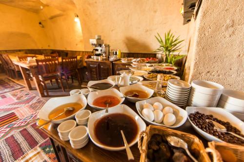 a table topped with plates of food at Tulip Cave Suites in Göreme