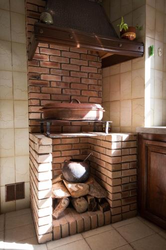 a brick oven in a kitchen with logs in it at Casa rural el Burro in Agüimes