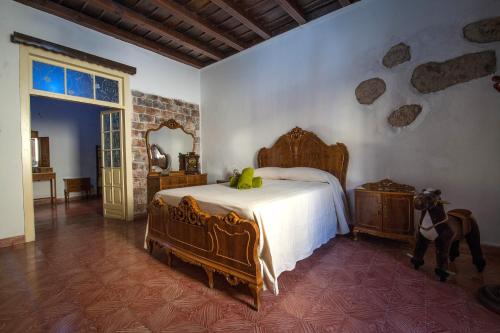 a bedroom with a bed and a horse standing next to it at Casa rural el Burro in Agüimes