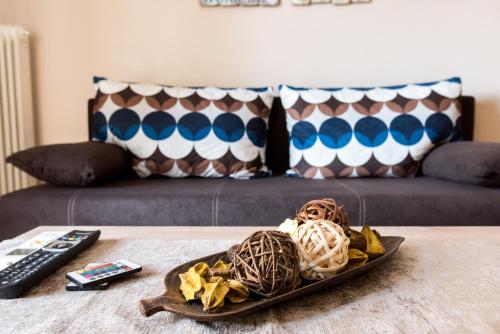 a plate of food on a table next to a couch at Gazi Divine Apartment in Athens