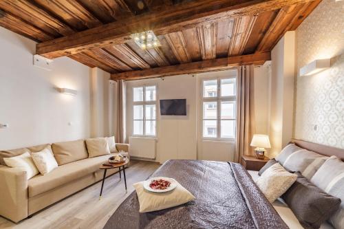 a living room with a couch and a table at Downtown Royal Apartments in České Budějovice