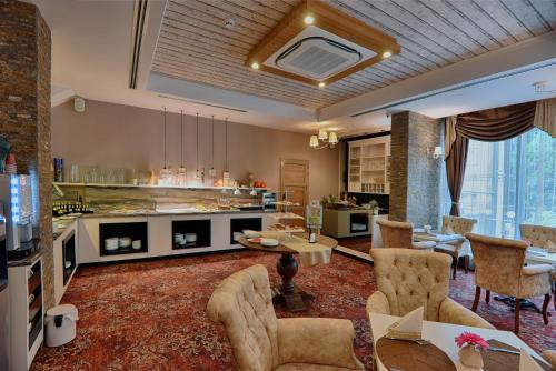 a large living room with a table and chairs at Best Boutique Hotel in Stara Zagora