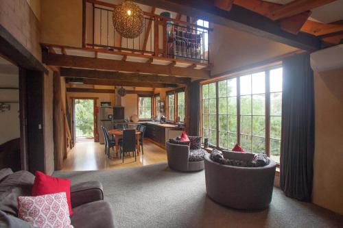 a living room with couches and chairs in a room at La Boheme Secluded Luxury Spa Villa in Daylesford