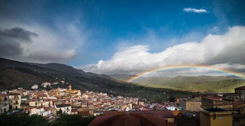 a city with a rainbow in the sky at Casa degli Artisti San Lorenzo in Mezzojuso