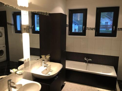 a bathroom with two sinks and a tub and a sink and a toilet at Löwenherz in Göstling an der Ybbs