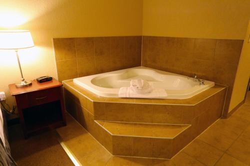 a bathroom with a tub with a towel on it at Lakeview Inns & Suites - Fort Nelson in Fort Nelson