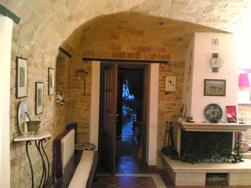 an entrance to a room with a stone wall at Bed&Breakfast Giardino Agritourist in Controguerra