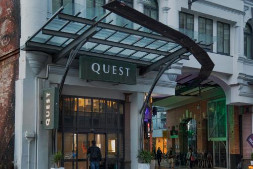 a store front with a sign for a quest at Quest Cathedral Junction Serviced Apartments in Christchurch