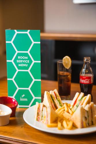 a plate of sandwiches and french fries and a drink at Boutique Hotel Baku in Baku