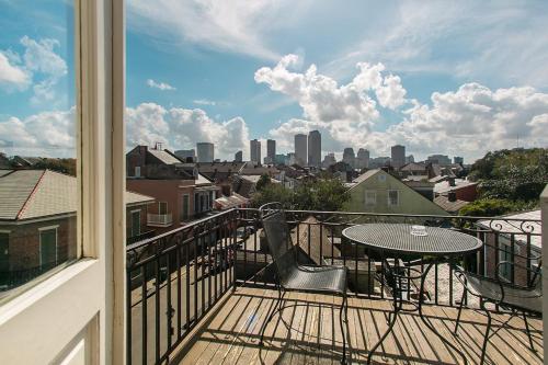 a balcony with a table and a view of a city at Lafitte Hotel & Bar in New Orleans