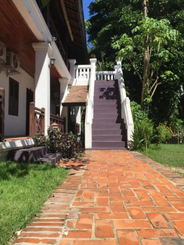 a brick walkway in front of a house at Ban Vivanh chambres d'hotes in Luang Prabang