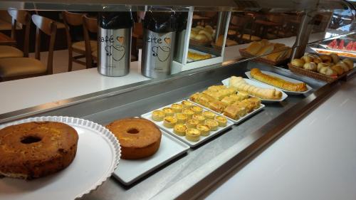 eine Vitrine mit verschiedenen Gebäcksorten und Donuts in der Unterkunft Hotel Piramide St. Antonio de Jesus in Santo Antônio de Jesus