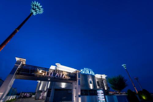 a building with a street light in front of it at Hotel Sulata Yamagata Airport in Higashine