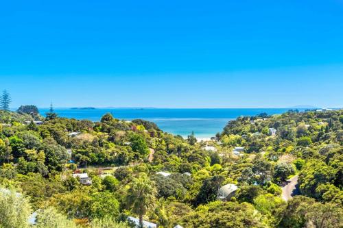 a view of the ocean from the top of a hill at Villa Casita at Palm Beach by Waiheke Unlimited in Palm Beach