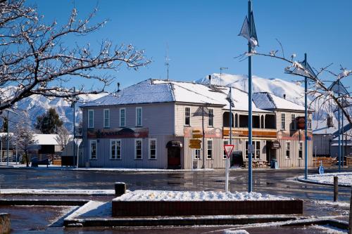a building with snow on it in front of a street at The Brown Pub in Methven