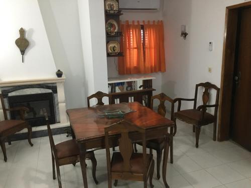 a dining room with a table and chairs and a fireplace at Painel de Monsaraz in Reguengos de Monsaraz