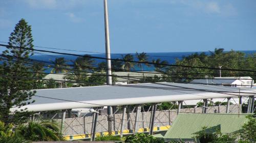 a row of solar panels on top of a building at Beauvalette in Sainte-Anne