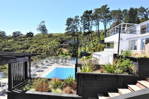 a view of a house with a swimming pool at Villa Topaz at Palm Beach by Waiheke Unlimited in Palm Beach