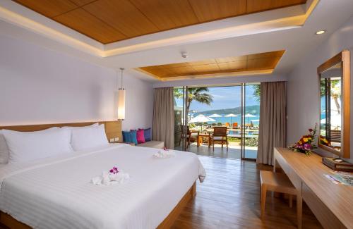 a bedroom with a large bed and a view of the ocean at Beyond Karon in Karon Beach