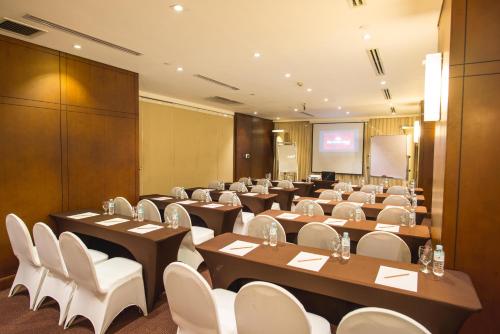 a conference room with tables and chairs and a screen at City Garden Hotel Makati in Manila