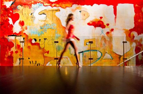 a woman walking in front of a wall with graffiti at Andaz San Diego - a Concept by Hyatt in San Diego