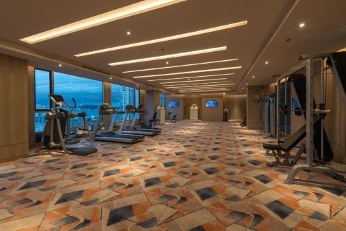 a gym with treadmills and exercise equipment in a hotel at Mytt Hotel Pattaya in Pattaya