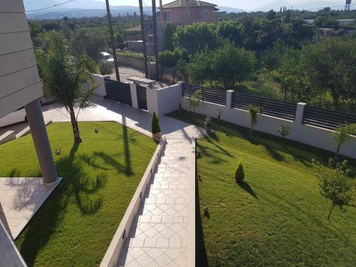 an overhead view of a yard with grass and a fence at Dimitris Villa in Aígio