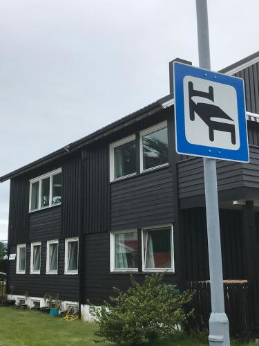 a street sign in front of a black building at Villa Åndalsnes in Åndalsnes