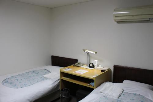 Кровать или кровати в номере Hotel Higashihiroshima Hills Saijo