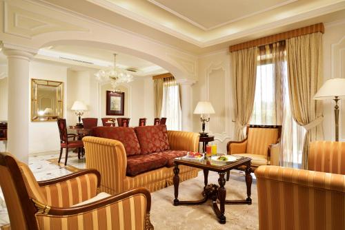 a living room with a couch and a table at Mercure Petriolo Siena Terme Spa Hotel in Bagni di Petriolo