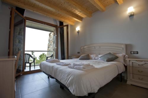 a bedroom with a large bed and a large window at Agroturismo Itxaspe in Orio