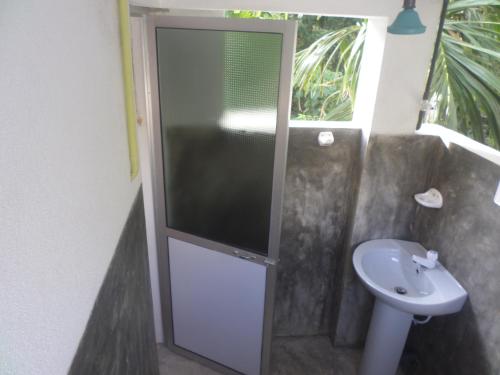 a bathroom with a toilet and a sink at Gold ocean house in Hiriketiya