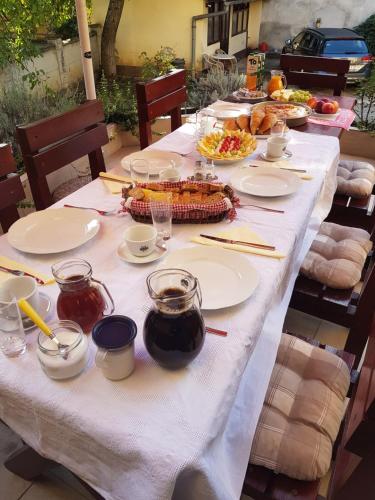 a long table with plates of food on it at Vila Regina rooms in Karlovac