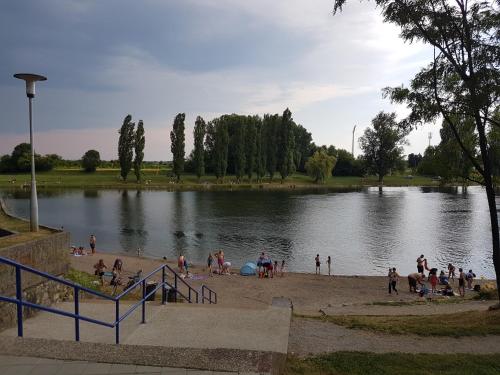 a group of people on a beach near a lake at Vila Regina rooms in Karlovac