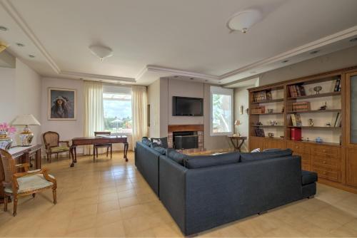 a living room with a couch and a table at Asterion Deep Blue Villa in Stavros