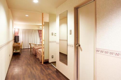 a room with a bed and a door to a bedroom at Izumigo Izukogen Dog Paradise Condominium in Ito
