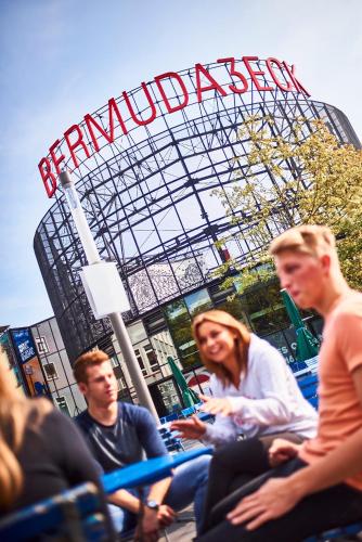 a group of people sitting in chairs in front of a ballpark at DJH-Gästehaus Bermuda3Eck in Bochum